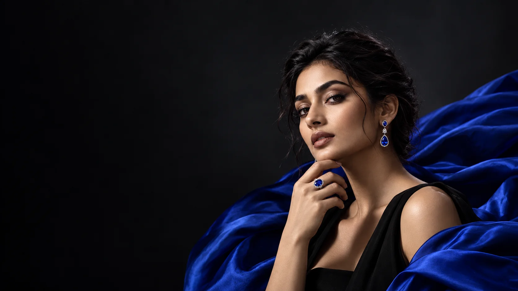 Maharis campaign concept: a model wearing blue gemstone jewellery against cobalt silk